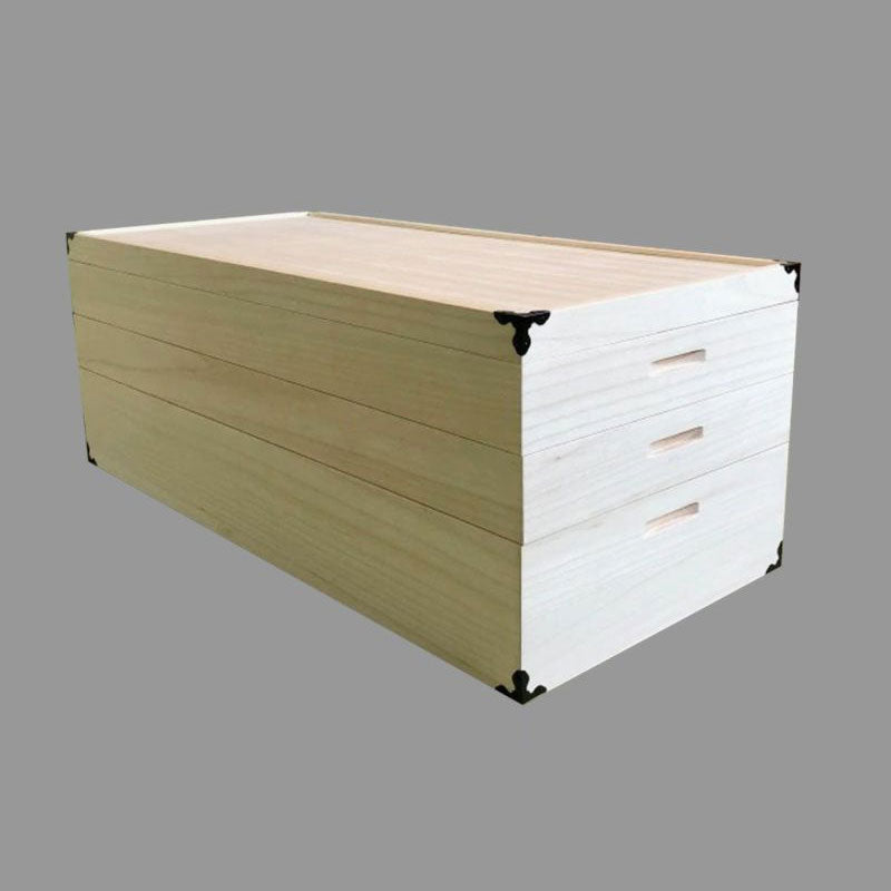 Cut-out image of a three-tier kimono storage made of paulownia wood. The wood has a white and smooth texture.