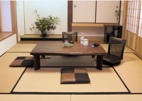 A premium solid wood Japanese kotatsu table set in a traditional washitsu room with tatami mats and floor chairs.