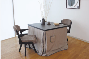 A modern Japandi style high-sitting kotatsu dining table with matching chairs and a sleek grey heater-cover futon.
